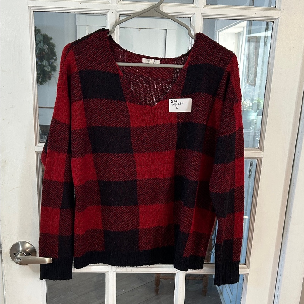 Q24.    Maunces Red and Black V-Neck Sweater